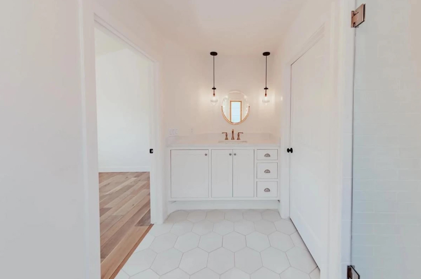 Hexagon tile bathroom flooring with vanity and pendant lighting